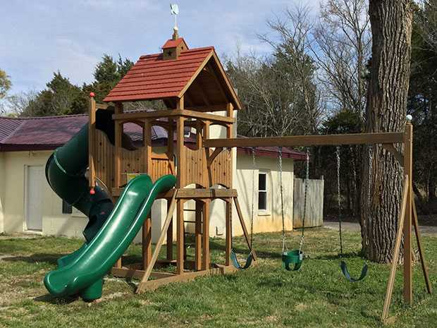 A custom playset with a tube slide, straight slide, and 3 position attachment