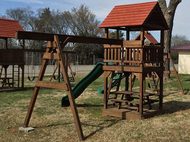 A Picnic Tower with a picnic table, slide, and 3 position attachment