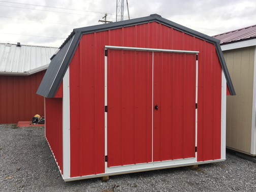 Red, White, and Black short metal building roughly 10x12