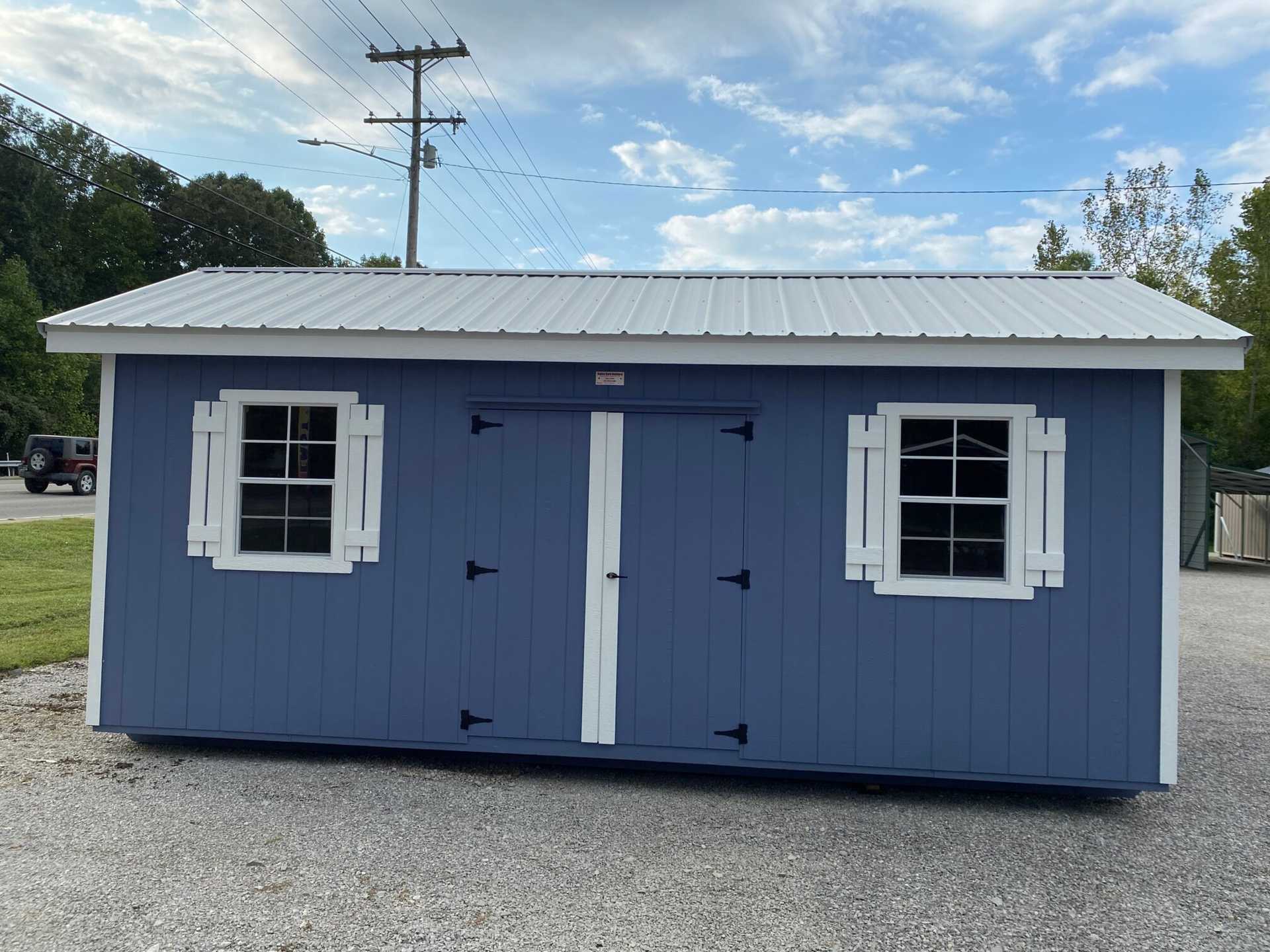10x20 Wood Utility Cabin. Distance Walls, White Trim and a Polar White Metal Roof. Includes 60" Double Doors, 2 - Windows, 2 - Pair of Shutters, 2 - 4' Lofts and Foil on Roof Only.