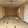 12x24 Classic Metal Garage. Gray Walls White Trim Slate Gray Roof. Options Include 8x7 Roll-up Door, Solid Panel Walk in Door, 1 - Window and Foil on Roof.