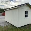 10x16 Premium Wood Utility Shed. Walls Stone, Trim Brown and Brown Metal Roof. Includes 1 - Window, 1 - 4' Loft and Roof Barrier. USED