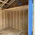 10x20 Wood Utility Cabin. Distance Walls, White Trim and a Polar White Metal Roof. Includes 60" Double Doors, 2 - Windows, 2 - Pair of Shutters, 2 - 4' Lofts and Foil on Roof Only.