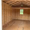 10x16 Premium Wood Utility Shed. Walls Stone, Trim Brown and Brown Metal Roof. Includes 1 - Window, 1 - 4' Loft and Roof Barrier. USED